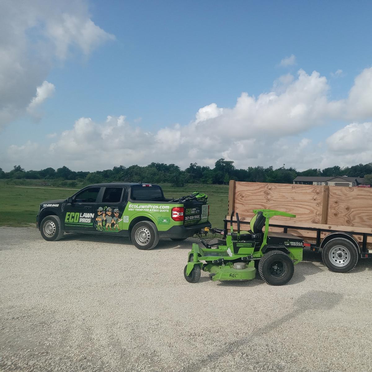 Eco Lawn Pros branded truck with battery-powered Greenworks commercial mower and trailer